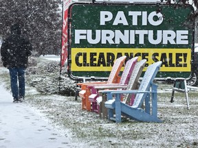 Definitely an end-of-season sale. Pedestrians pass a shop where patio furniture is on clearance along 99 Street near 52 Avenue on October 14, 2016.