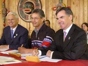B.C. Premier Gordon Campbell (left), Federal Minister of Indian Affairs and Northern Development Jim Prentice (right) and Chief Negotiator for First Nations Nathan Matthew (centre) sign agreement that will lead to First Nations jurisdiction over First Nations' education in British Columbia in July 2006.