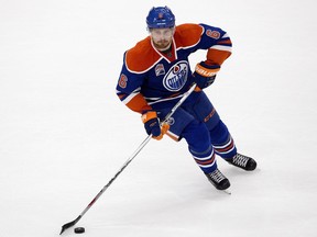 The Edmonton Oilers' Adam Larsson (6) battles the Calgary Flames during third period pre-season NHL action at Rogers Place, in Edmonton on Monday Sept. 26, 2016.