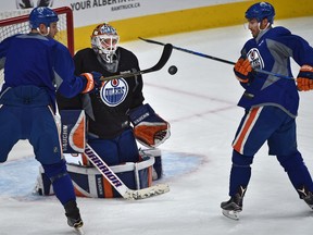 Oilers Jordan Eberle (14, R) and Zack Kassian (44) try to bat at the puck in front of goalie Jonas Gustavsson during practice at Rogers Place in Edmonton Tuesday, October 25, 2016. Ed Kaiser/Postmedia (Edmonton Journal story) Video/photos off Oilers practice for multiple writers' copy in Oct. 26 edition