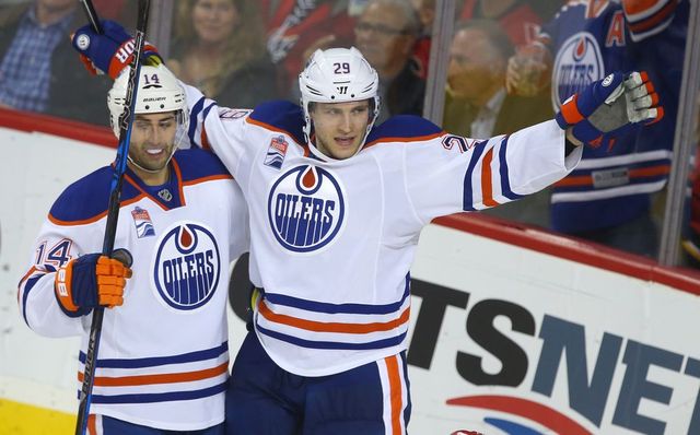 Oilers forwards Jordan Eberle (L) and Leon Draisaitl celebrate a third period goal during NHL action between the Edmonton Oilers and the Calgary Flames in Calgary on Oct. 14, 2016.
