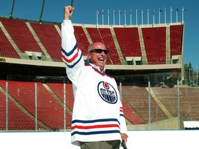 Patrick LaForge, president of the Edmonton Oilers, exhults after shooting a ceremonial puck into the net on the plastic surface installed at Commonwealth Stadium. A hockey rink was erected on the field at Commonwealth to test conditions for the Heritage Classic.