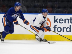 Drake Caggiula is chased by Connor McDavid during an Edmonton Oilers' practice at Rogers Place, in Edmonton on Wednesday Oct. 5, 2016.