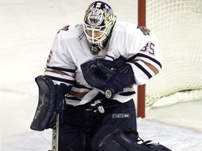 Edmonton Oilers goaltender Tommy Salo makes a save late in the third period in a game against the Minnesota Wild in Edmonton Tuesday, April 3, 2002.