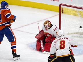 The Edmonton Oilers' Patrick Maroon (19) scores on battles the Calgary Flames' goalie Brian Elliott (1) during first period NHL action at Rogers Place, in Edmonton on Wednesday Oct. 12, 2016. The first Oilers' regular season goal at Rogers Place. Photo by David Bloom Photos off Oilers game for multiple writers copy in Oct. 13 editions.