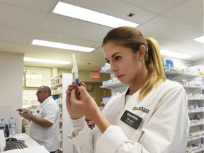 Pharmacist Megan Albinati prepares a flu vaccine at Shamrock Pharmacy on Sept. 28, 2016 in Grande Prairie, Alta.