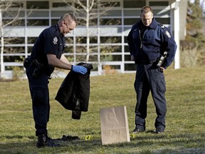 Police collect clothing and a mobile phone found near the scene of a suspicious death near Fox Drive on Saturday Oct. 22, 2016.