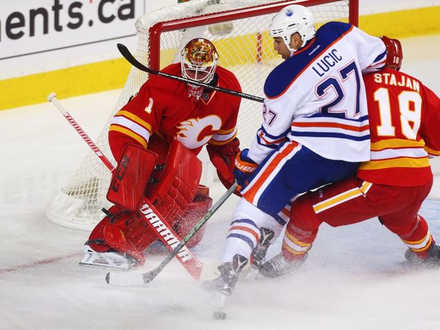 Calgary Flames Brian Elliott makes a save on Milan Lucic of the Edmonton Oilers during NHL hockey in Calgary, Alta., on Friday, October 14, 2016. AL CHAREST/POSTMEDIA