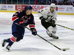 Regina Pats forward Sam Steel is watched by Red Deer Rebels defenceman Josh Mahura during WHL action at the Brandt Centre in Regina on Oct. 2, 2016.
