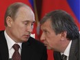 In this photo taken on July 2, 2013, Russia President Vladimir Putin (left) talks to Rosneft president Igor Sechin during a signing ceremony at the Kremlin in Moscow.