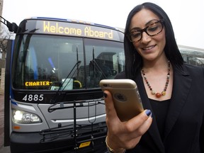 Priya Bhasin-Singh, Team Lead Customer Engagement and Retention at Edmonton Transit, poses for a a photo while using the third-party app Transit. On Tuesday, the City announced Edmonton Transit has finished installing Smart Bus technology on all 928 buses in its fleet.
