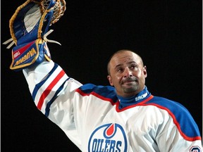 Grant Fuhr waves to fans at Skyreach Centre Oct. 9, 2003, during a ceremony commemorating his years as goalie with the Edmonton Oilers.