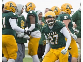 Tak Landry of the Alberta Golden Bears, celebrates after the Bears won their first game of the seasons against  the University of Regina Rams at Foote Field in Edmonton  on October 15, 2016. The Bears defeated the Rams 19-18.