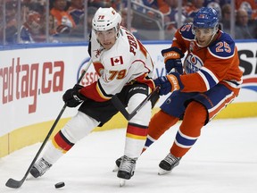 Edmonton's Darnell Nurse (25) battles Calgary's Matt Stajan (18) during the first period of a NHL game between the Edmonton Oilers and the Calgary Flames at Rogers Place in Edmonton, Alberta on Wednesday, October 12, 2016. Ian Kucerak / Postmedia Photos off Oilers game for multiple writers copy in Oct. 13 editions.