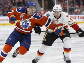 Edmonton's Connor McDavid (97) and Calgary's Mikael Backlund (11) battle during the third period of a NHL game between the Edmonton Oilers and the Calgary Flames at Rogers Place in Edmonton, Alberta on Wednesday, October 12, 2016. Ian Kucerak / Postmedia Photos off Oilers game for multiple writers copy in Oct. 13 editions.