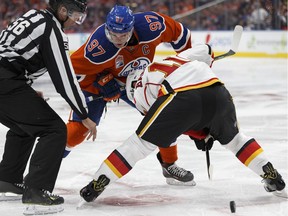 Edmonton's Connor McDavid (97) and Calgary's Mikael Backlund (11) faceoff during the third period of a NHL game between the Edmonton Oilers and the Calgary Flames at Rogers Place in Edmonton, Alberta on Wednesday, October 12, 2016.