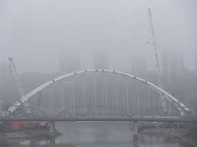 The Walterdale Bridge replacement construction site is seen from the High Level Bridge during an evening fog warning in Edmonton, Alberta on Thursday, Oct. 27, 2016. Delays in the bridge project, in part, led to delays with planning for the Touch the Water Promenade.