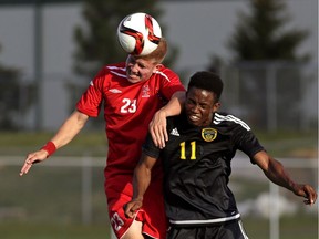 University of Calgary Dinos defender Jared Fillo (left) heads the ball beside University of Alberta Golden Bears forward Tolu Esan (right) during university soccer game action at Foote Field in Edmonton on Wednesday August 24, 2016.