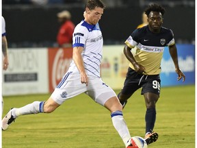 FC Edmonton midfielder Daryl Fordyce plays a ball with Jacksonville Armada midfielder Charles Eloundou looking on in North American Soccer League play, Wednesday Sept 28, 2016 in Jacksonville, Florida. FC Edmonton host the Indy Eleven on Sunday (2 p.m.) at Clarke Stadium.