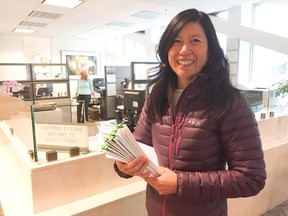 Paths for People's Anna Ho delivers 46 letters Friday in support of the downtown cycle tracks to city council.