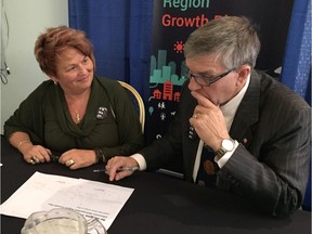 St. Albert Mayor Nolan Crouse, chair of the Capital Region Board, and Strathcona County Mayor Roxanne Carr, head of the growth plan committee, sign letters recommending the newly approved growth plan to the province.