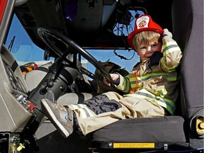 Weston Driscoll, two, at the steering wheel of a fire truck at the new Lewis Farms Fire Station 29 in west Edmonton, which officially opened Saturday.