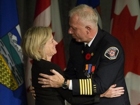 Premier Rachel Notley embraces Fort McMurray fire Chief Darby Allen during a ceremony to recognize the heroes of the Fort McMurray wildfire at the Alberta legislature, in Edmonton on Monday, Oct. 31, 2016.