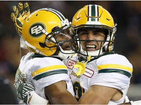 Edmonton Eskimos' Adarius Bowman (4) celebrates his touchdown with Julian Feoli-Gudino (83) during the first half of CFL action the Winnipeg Blue Bombers in Winnipeg Friday, September 30, 2016.