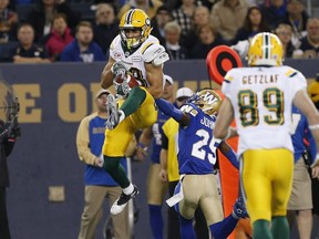 Edmonton Eskimos' Brandon Zylstra (83) snags the pass in front of Winnipeg Blue Bombers' Bruce Johnson (25) during the first half of CFL action in Winnipeg Friday, September 30, 2016.