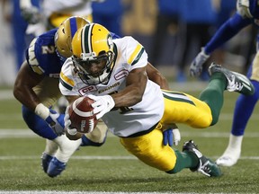 Edmonton Eskimos' Adarius Bowman (4) dives in for the touchdown against Khalil Bass (2) and the Winnipeg Blue Bombers during the first half of CFL action in Winnipeg Friday, September 30, 2016.