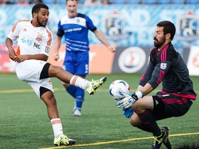 FC Edmonton goalkeeper Matt VanOekel, right, makes a save against Carolina RailHawks striker  Jonathan Orlando, left, during NASL soccer action on Sunday, July 31, 2016. VanOekel and FC Edmonton travel to face the Indy Eleven in a NASL semifinal on Saturday.