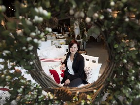 Wabi Sabi Home & Design Studio owner/designer Gwen Saunter-Davis is framed by a Christmas wreath.