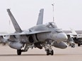 A pilot positions a CF-18 Hornet at the CFB Cold Lake, in Cold Lake, Alberta on Tuesday, October 21, 2014.