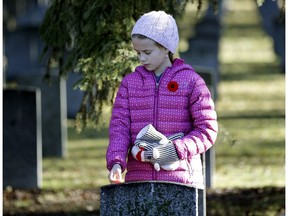 Abby Johnston (10-years-old) reflects on Remembrance Day at Beechmount Cemetery in Edmonton on Monday November 7, 2016 where the No Stone Left Alone ceremony was held.