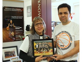 Angelica Sanchez-Castaleda, left, and Marco Salinas-Garcia, right, hold a picture of their daughter Fernanda Salinas-Sanchez and her basketball team, the Westminster Warriors, during a tournament at Westminster School at 13712 104 Ave. in Edmonton on Nov. 26, 2016. Fernanda, 16, was killed in a car accident on July 25, 2016, in Mexico while visiting family.