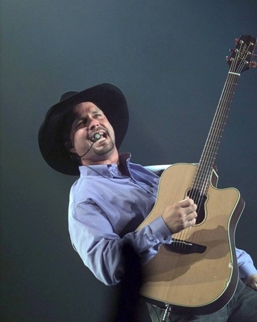LOCAL CAPTION: Garth Brooks fires up Coliseum crowd into a delighted frenzy Saturday./ 960810.WON BROOKS CONCERT (DIGITAL)
EDMONTON FOLK MUSIC FESTIVAL 1996
Edmonton-08/10/96-BROOKS CONCERT 2-Garth Brooks performs to a sold out audience today. Photo by Larry Wong/Edmonton Journal.