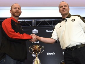 Calgary Stampeders head coach Dave Dickenson, left, and Ottawa Redblacks head coach Rick Campbell shake hands before they take part in press conferences in Toronto on Wednesday, November 23, 2016. The teams are preparing for Sunday's Grey Cup.