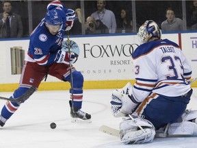 Edmonton Oilers goalie Cam Talbot (33) blocks a shot by New York Rangers center Derek Stepan (21) during the second period of an NHL hockey game Thursday, Nov. 3, 2016, at Madison Square Garden in New York.