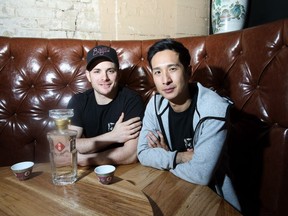 Chef Alexei Boldireff, left, and bartender Tommie Cheng pose  at a table in Baijiu, a restaurant opening in Mercer Warehouse.