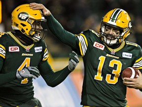 Edmonton's Adarius Bowman and quarterback Mike Reilly celebrate a touchdown during the Canadian Football League Western Final between the Edmonton Eskimos and the Calgary Stampeders at Commonwealth Stadium in Edmonton, Alta., on Sunday, Nov. 22, 2015. The Eskimos won 45-31. Codie McLachlan/Edmonton Sun/Postmedia Network