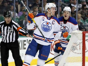 Edmonton Oilers center Connor McDavid (97) and Jesse Puljujarvi (98) of Sweden celebrate a goal by McDavid in the second period of an NHL hockey game against the Dallas Stars on Saturday, Nov. 19, 2016, in Dallas. The score was McDavid's second of the game.