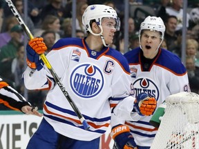 Edmonton Oilers center Connor McDavid (97) and Jesse Puljujarvi (98) of Sweden celebrate a goal by McDavid in the second period of an NHL hockey game against the Dallas Stars on Saturday, Nov. 19, 2016, in Dallas. The score was McDavid's second of the game.