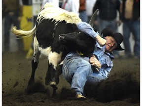 Curtis Cassidy from Donalda, AB, scores a 5.2 seconds in the steer wrestling competition during the matinee of the Canadian Finals Rodeo at Northlands Coliseum in Edmonton, Saturday, November 12, 2016.