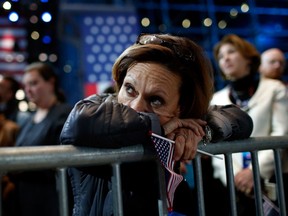 A woman holds an American flag as she watches the voting results at Democratic presidential nominee former Secretary of State Hillary Clinton's election night event at the Jacob K. Javits Convention Center  on Nov. 9, 2016 in New York City. Clinton  lost to Republican Donald Trump, despite polls prior to election day predicting her win.