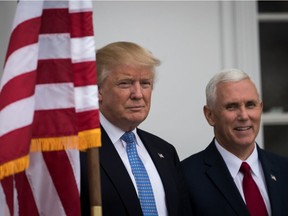 President-elect Donald Trump and vice president-elect Mike Pence listen to a question from the press before their meeting with investor Wilbur Ross at Trump International Golf Club on Nov. 20, 2016 in Bedminster Township, N.J. Trump and his transition team are in the process of filling cabinet and other high level positions for the new administration.
