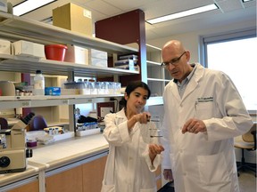 Dr. Todd McMullen, clinical professor of surgery and oncology at the University of Alberta, is speaking with Ana Lopez-Campistrous, a research associate in McMullen's lab.