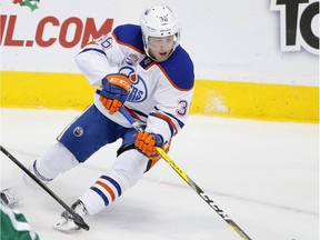 Edmonton Oilers left wing Drake Caggiula (36) gains control of the puck behind Dallas Stars' John Klingberg (3) of Sweden and Patrick Sharp (10) in the third period of an NHL hockey game, Saturday, Nov. 19, 2016, in Dallas.