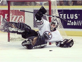 Edmonton Oilers goalie Curtis Joseph makes a save at Edmonton Coliseum during NHL action against the Anaheim Mighty Ducks on Nov. 28, 1997.