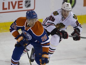 Edmonton Oilers  Darnell Nurse (25) is chased by Chicago Blackhawks Ryan Garbutt (28) during first period NHL action on November 18, 2015, in Edmonton.