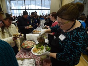 Volunteers helps out at annual Bissell Centre New Year's dinner at the Boyle Street Plaza in Edmonton on Thursday Jan. 1, 2015.